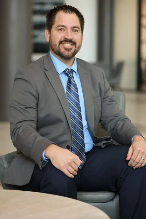 Image showing Marc Dunbar, Director of Operations and Services, sitting in a chair